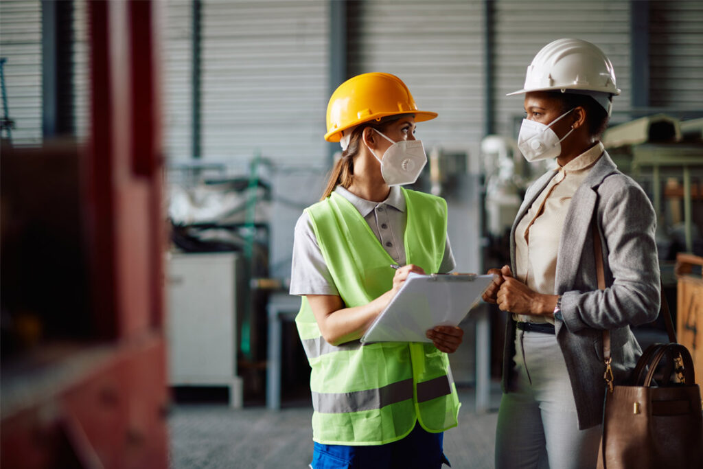 Integrated management system auditor conducting environmental and occupational safety compliance inspections at an industrial facility