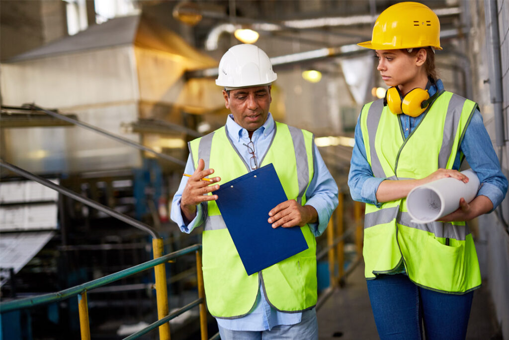 Lead auditor reviewing integrated environmental and occupational health and safety management system compliance at an industrial site