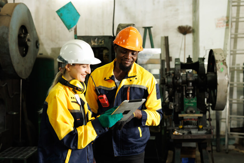 Industrial safety professionals conducting a workplace safety inspection in a manufacturing facility