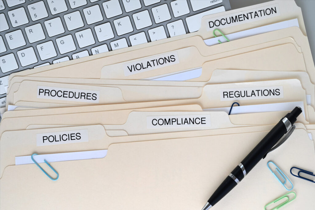 Information security professionals reviewing cybersecurity and data protection procedures in a corporate office environment