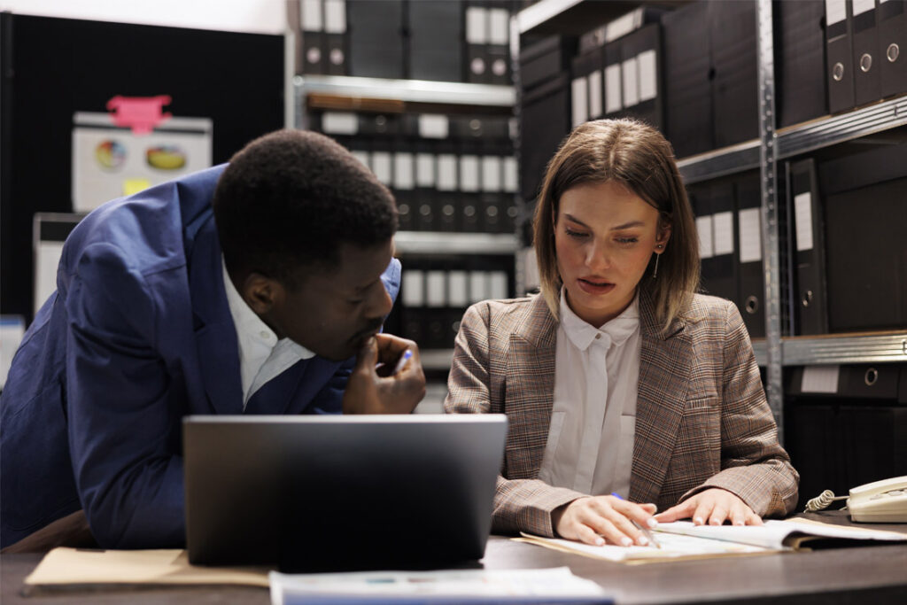 Auditor reviewing anti-bribery compliance procedures and governance controls in a corporate environment