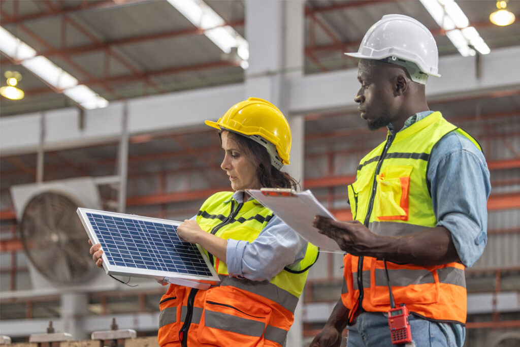 Energy management auditor reviewing energy efficiency and operational performance procedures in an industrial facility