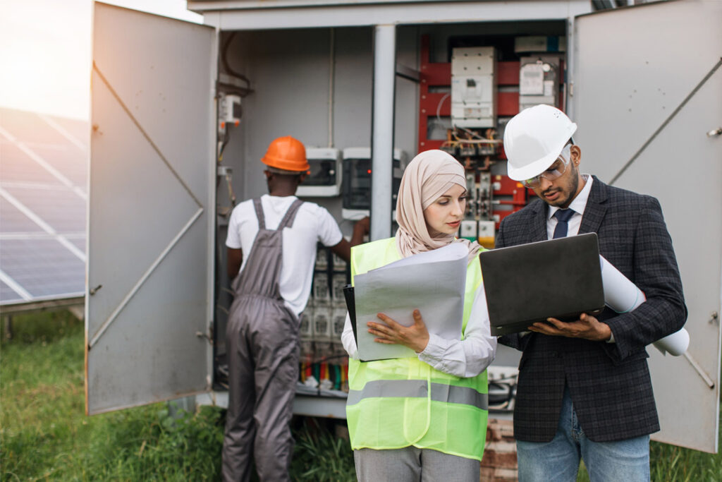 Energy management professionals implementing energy efficiency procedures in an industrial environment