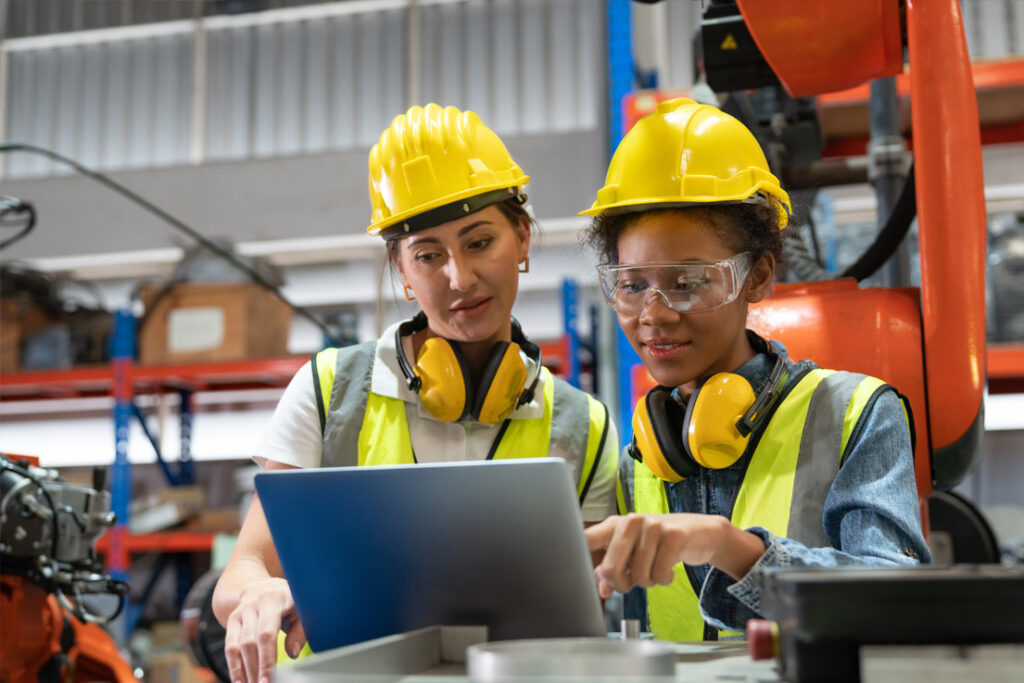 Manufacturing team reviewing mistake-proofing and quality control procedures in an industrial environment