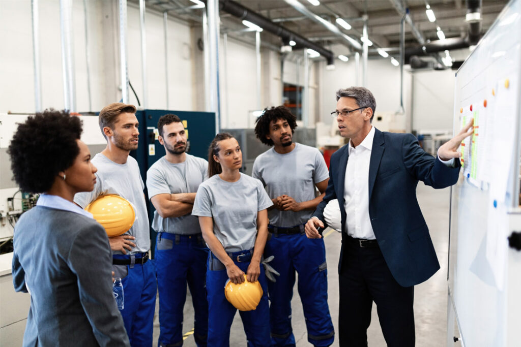 Quality management professionals implementing operational procedures in a manufacturing environment